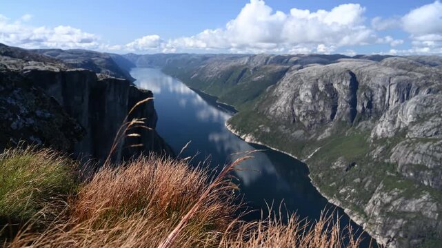 Kjeragbolten Viewpoint Over Lysefjord Fjord with Swaying Autumn Grass and Rocky Cliffs Norway
