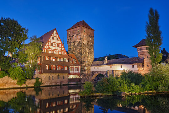 Night view of the picturesque Henkersteg bridge and traditional houses in the old town of Nuremberg, Bavaria, Germany.