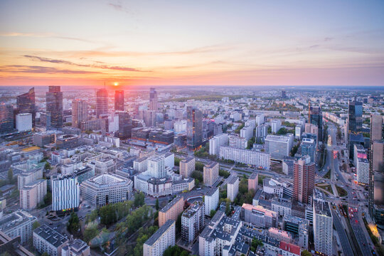 High viewpoint over the Warsaw skyline in Poland with skyscrapers, cityscape layers, city depth, sunset color and dramatic sky