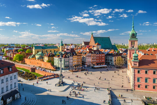 Elevated skyline view over Castle Square in Warsaw with the Royal Castle, Sigismunds Column, St Johns Archcathedral, Old Town houses, and clouds
