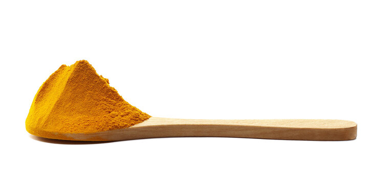 Turmeric (Curcuma) powder pile in wooden spoon isolated on white background, side view