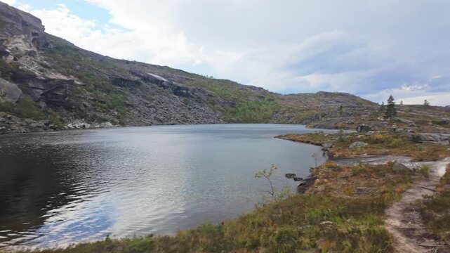 Serene Alpine Lake Surrounded by Dramatic Dark Granite Cliffs in Rago National Park Wilderness, Norway