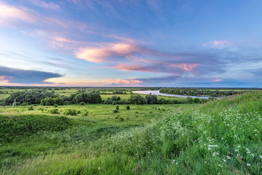 Soft pastel clouds drift above the horizon