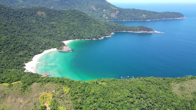 Cinematic aerial drone shot of the remote Praia de Antigos beach surrounded by lush rainforest, Paraty, Brazil &ndash; 2025