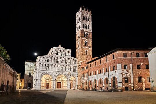 Lucca, Tuscany, Italy: night view of the medieval Roman Catholic Cathedral of St Martin of Tours, a masterpiece of art and architecture, in the historic center of the ancient Tuscan city