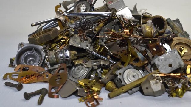 Time-lapse slow-motion footage of brass scrap accumulation ,growing from a single piece into a large pile.