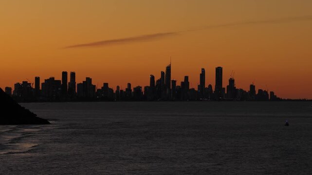 Static aerial drone shot overlooking the Surfers Paradise and Broadbeach skyline from Burleigh Headland at twilight on the Gold Coast, Queensland, Australia