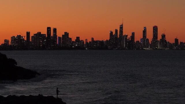 Static aerial drone shot overlooking the Surfers Paradise and Broadbeach skyline from Burleigh Headland at twilight on the Gold Coast, Queensland, Australia