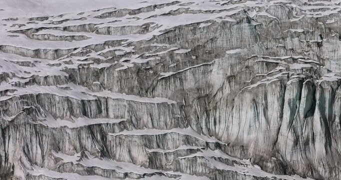 Everest region, Nepal, aerial gliding shot of deep crevasses and rugged ice formations across a massive glacial icefall
