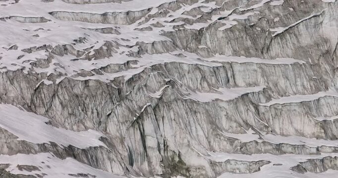 Cho Oyu mountain Everest region Nepal, aerial orbit shot of unique glacial ice formation structures and crevasses across a high altitude Himalayan glacier.