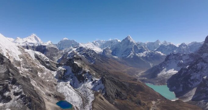 Chola Pass Everest region Nepal, aerial drone shot revealing Ama Dablam mountain, Chola Tshe Lake, Lobuche Peak, and Mount Everest in a single high-altitude alpine landscape sequence