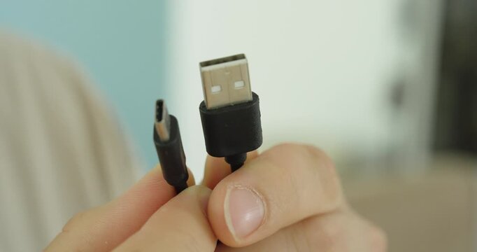 Close-up of USB Type-A and USB-C connectors held in hand, demonstrating modern data transfer, charging technology, device connectivity, and computer accessories.