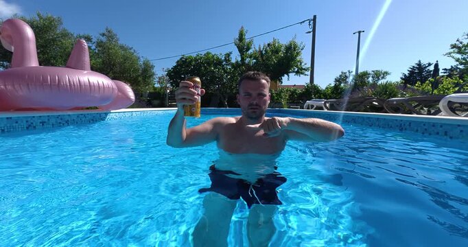 Man standing in a swimming pool holding a beverage and raising a warning finger, illustrating pool safety rules, prohibited drinks in the water, responsible behavior, and recreational safety