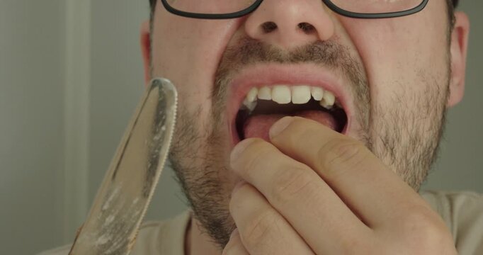 person licking a knife blade and then experiencing a cut on the tongue. Safety awareness concept highlighting the dangers of improper handling of sharp objects.