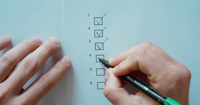 Close-up of a person checking completed items on a printed checklist with a marker pen. Quality control, inspection, task management, verification, and business administration concept.