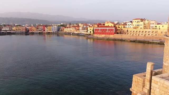  View of Chania with the amazing lighthouse, mosque, venetian shipyards, Crete, Greece.Waves crashing on lighthouse, Beautiful Greece and best scenic places - panorama