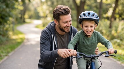 Fototapeta premium Happy caucasian father teaching his joyful little toddler son how to ride a bicycle in a sunny park road, active lifestyle family parenting and childhood development summer recreation outdoor.