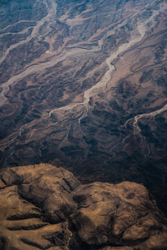 Aerial view of the arid landscape in Kenya, featuring intricate dry riverbeds and eroded terrain patterns in Nairobi, Nairobi County, Kenya.