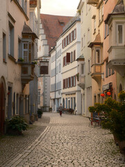 Fototapeta premium Quiet Cobblestone Alley in Historic European Old Town at Soft Morning Light