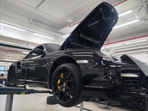 Moscow, Russia - June 26, 2026: A Porsche 911 sports car (model 997 Turbo Cabrio) is on a lift at a car service center. It is undergoing repairs and maintenance. 