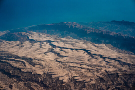 Aerial view of the rugged arid terrain and deep canyons of the Great Rift Valley in Nairobi, Nairobi County, Kenya.
