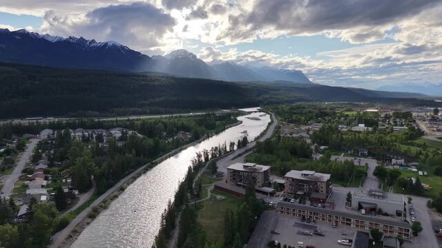Aerial View of Jasper Town with Athabasca River and Rocky Mountains Under Dramatic Sky, Alberta
