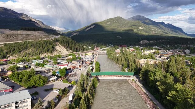 Aerial Drone View of Golden BC with Kicking Horse River Bridge and Surrounding Mountain Valley