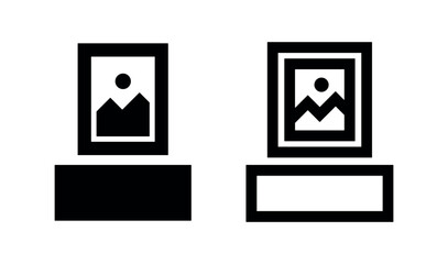 Fototapeta premium Icons of framed artwork on a pedestal, representing art and exhibition.