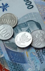 Indonesian rupiah money bills and coins on table. Indonesia cash of IDR currency © Larysa