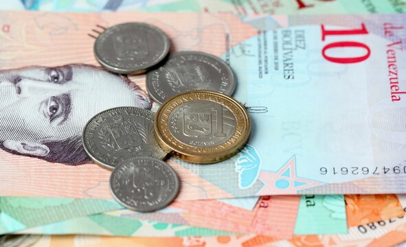 Venezuelan bolivar money bills and coins on table. Venezuela cash of VES currency close up