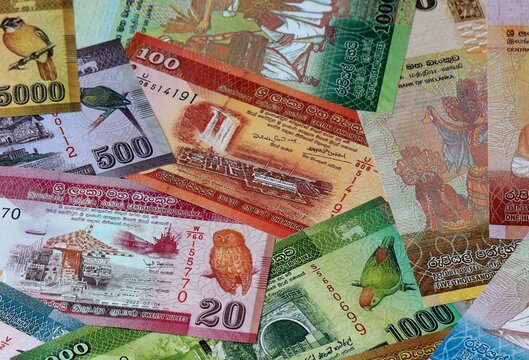 Sri Lankan rupee money banknotes bunch on table. Sri Lanka bills of LKR currency close up