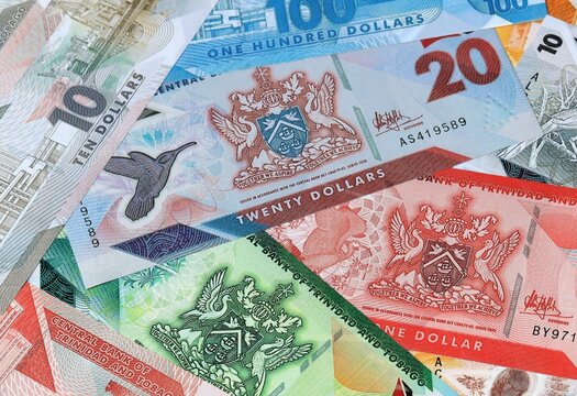 Trinidad and Tobago dollar money banknotes bunch on table. Trinidad and Tobago bills of TTD currency