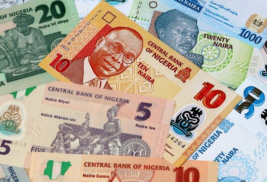 Nigerian naira money banknotes bunch on table. Nigeria bills of NGN currency close up