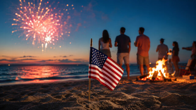 American flag on beach at sunset during fourth of July celebration, fireworks in sky, people gathered by bonfire, patriotic summer evening, celebrating USA independence day, festive atmosphere