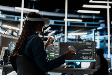 Obraz premium Data center technician uses a VR headset to inspect AI neural networks and server systems in a high-tech facility.