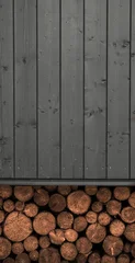 Wooden black wall with wood logs stacked under the house © Ayman Alakhras