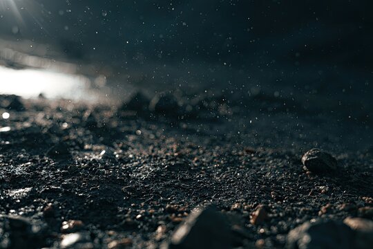Close-up of damp, textured earth with dust motes suspended in the air