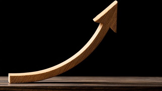 Wooden arrow curves upward on a dark surface, symbolizing growth and progress