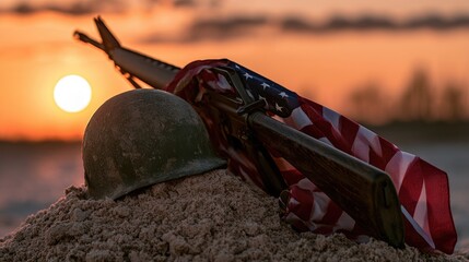 Fototapeta premium A helmet, rifle, and flag rest in sand at sunset