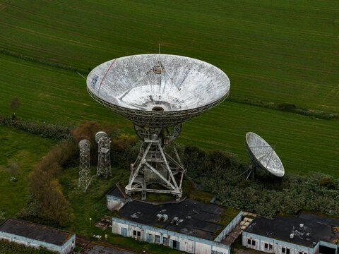 Aerial view of large satellite dishes and radio telescope antennas situated in a green field on Sao Miguel Island, Azores, Portugal.