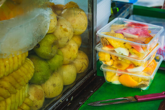 Indonesian sliced rujak fruit pieces in plastic containers at street food stall