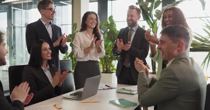 Business team applause in office meeting. People and colleagues applaud as professionals close a deal, showing unity and recognition in a bright workspace. Concept of success and teamwork.