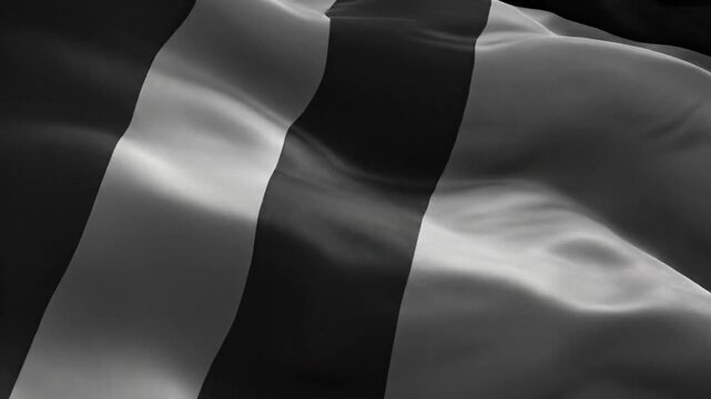 Black and white flag with vertical stripes waving slowly in a dark environment creating a soft flowing effect