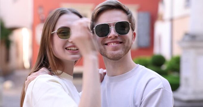 Lovely couple in sunglasses on city street