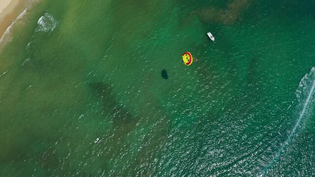 Parasailing In The Calm Blue Water Of Da Nang Beach In Summer In Vietnam. - aerial shot