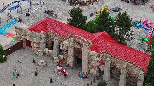 Entrance To Dinosaur-themed Attraction In Zatorland In Energylandia, Zator, Poland. - aerial shot