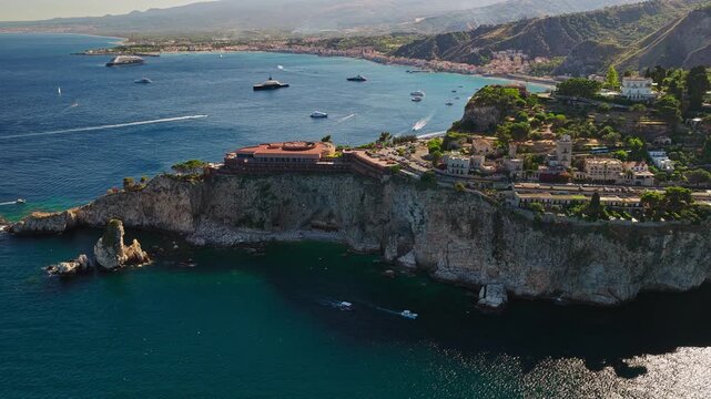 Isola Bella Viewpoint At Sunrise In Taormina, Metropolitan City of Messina, Italy. Aerial Sideways Shot