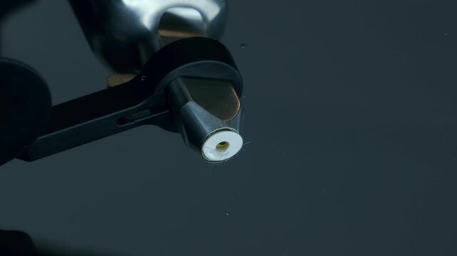 Windshield repair injector tool positioned over chipped cracked vehicle glass with cracks visible