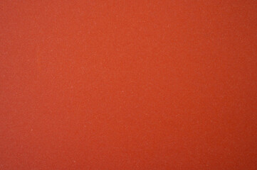 Fototapeta premium Full frame shot of orange paper sheet. Colored paper or construction paper, is a type of paper that comes in a wide range of colors.