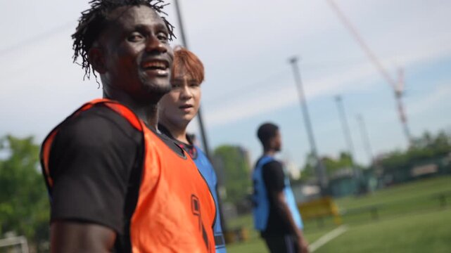 Passionate youth soccer teams practice and compete on an outdoor field under professional supervision. Coaches and referees support young athletes as they improve technical abilities, teamwork.